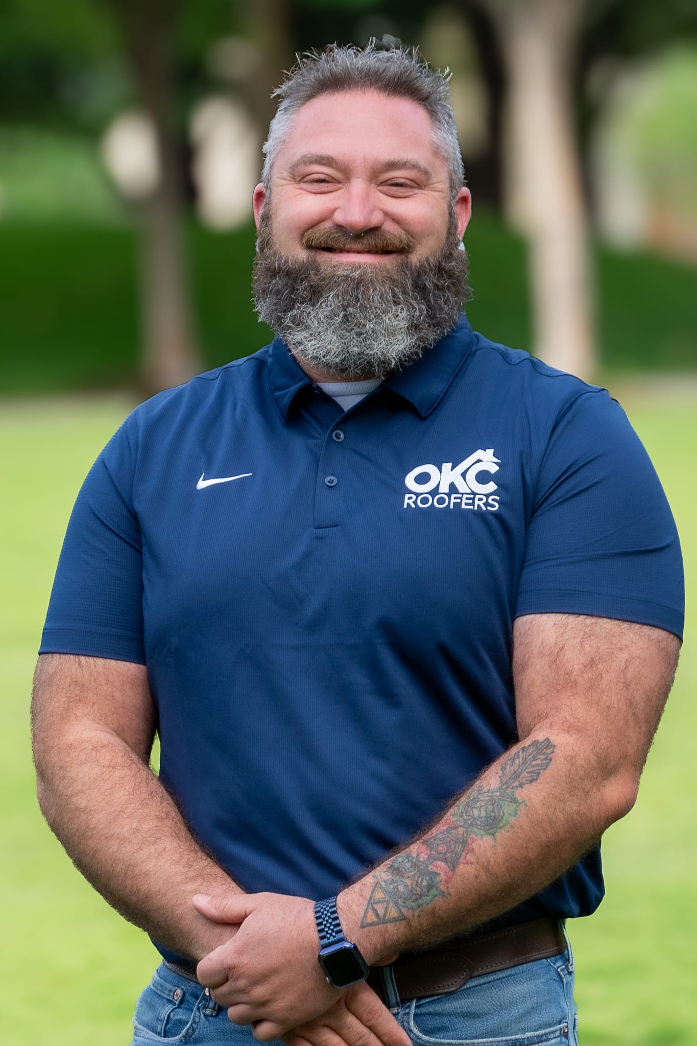 Smiling man in blue polo shirt