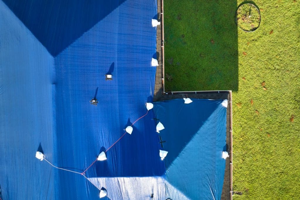 aerial view of blue roof tarping