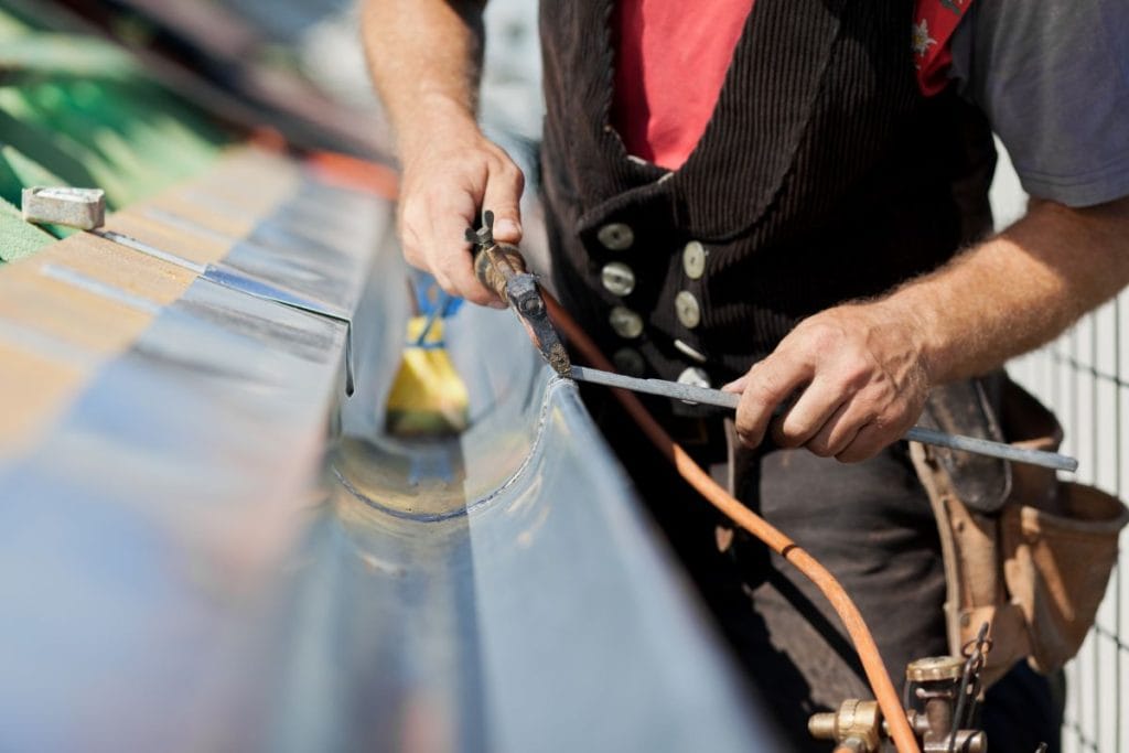 guy replacing gutter